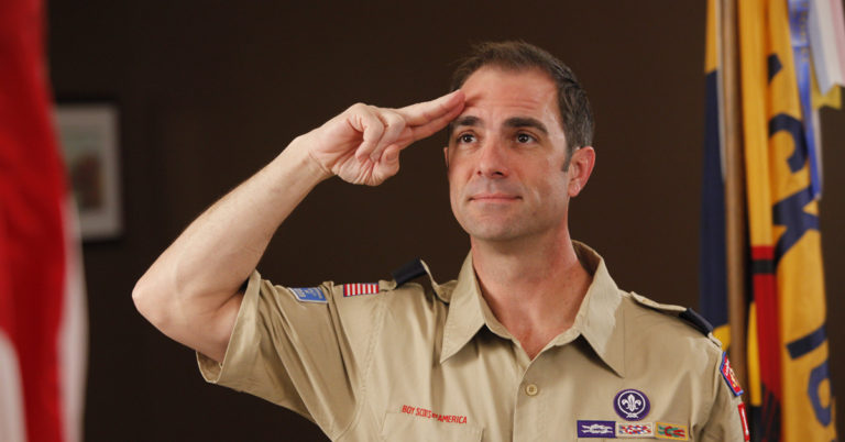 Cub Scout leader saluting