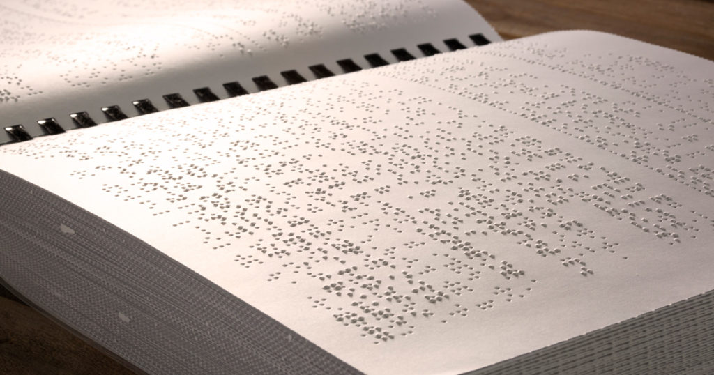 An inside spread of the Braille edition of the Wolf Handbook.