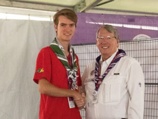 Jean Perea shaked hands with Scott Sorrels after Sorrels presented Jean with the National Medal of Merit.