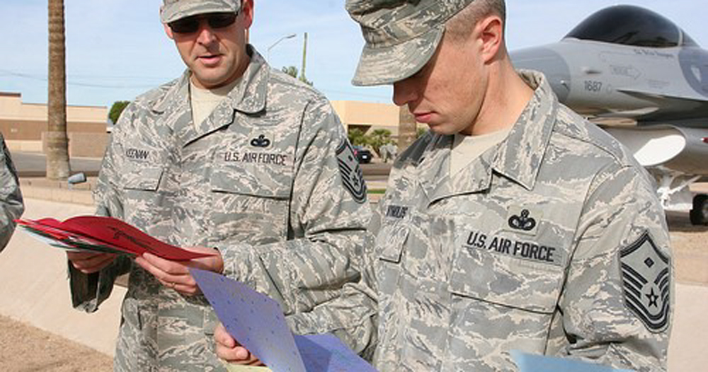 Two soldiers reading holidays cards