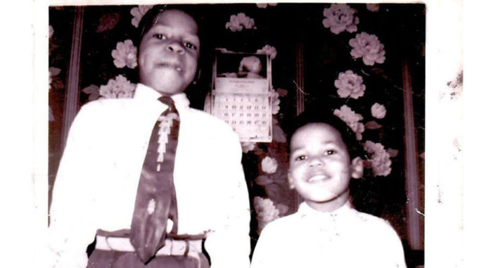 Elijah Cummings and his brother smile at the camera.