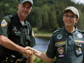 Kyle Dimick shakes hand of law enforcement officer