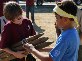 Two Scouts work on a lashing