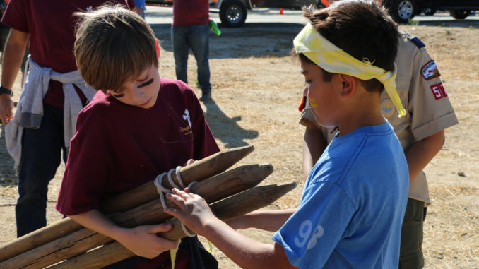 Two Scouts work on a lashing