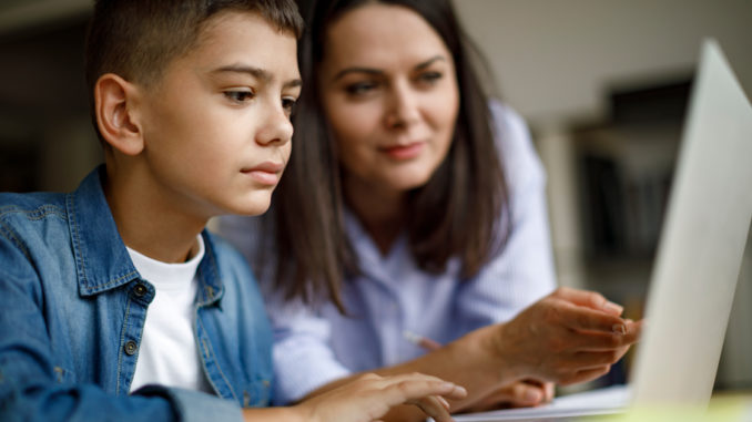 Mother and son looking at laptop