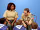Two Cub Scouts leaders talking to a group of Cub Scouts