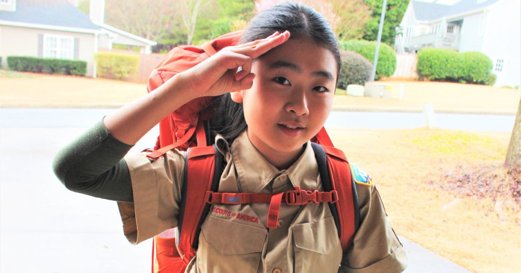 Sarah demonstrates the Scout salute.