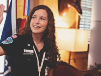 Aven Alexander shows the Scout sign