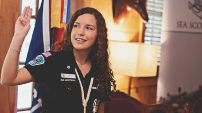 Aven Alexander shows the Scout sign