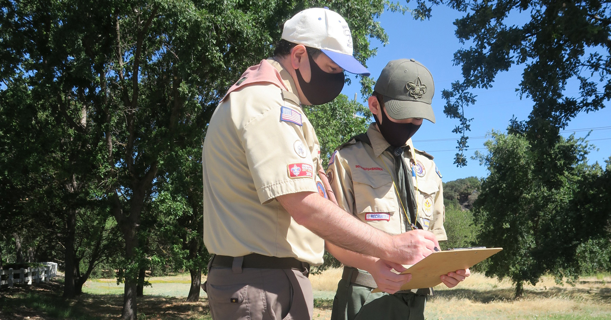 Trevor and his dad, Steve, look at clues during the mystery hike.