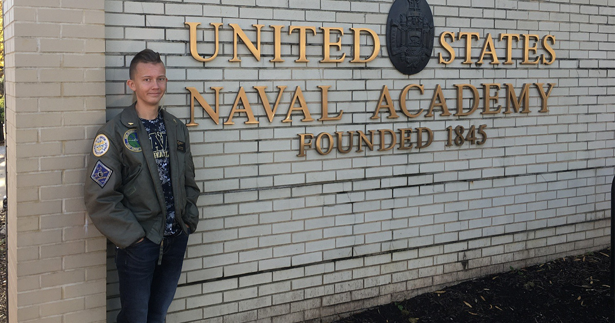 Ryan Cleasby in front of U.S. Naval Academy sign