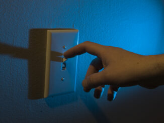 A person turning off the lights for Earth Hour