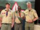 Darrell White stands between his Scoutmaster and a youth member of Troop 77