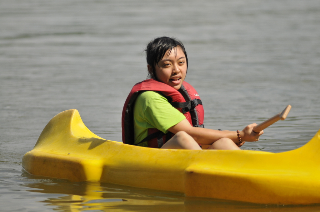 Kayaker showing aquatics safety by wearing a life jacket