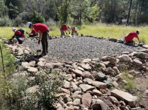 Scouts perform maintenance on the helipad.