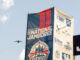 A photo of a plane flying past a National Jamboree sign