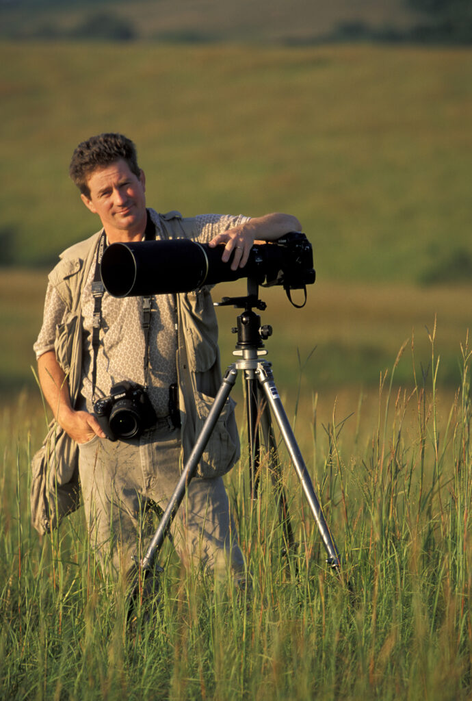 A photo of photographer Joel Sartore on the prairie.