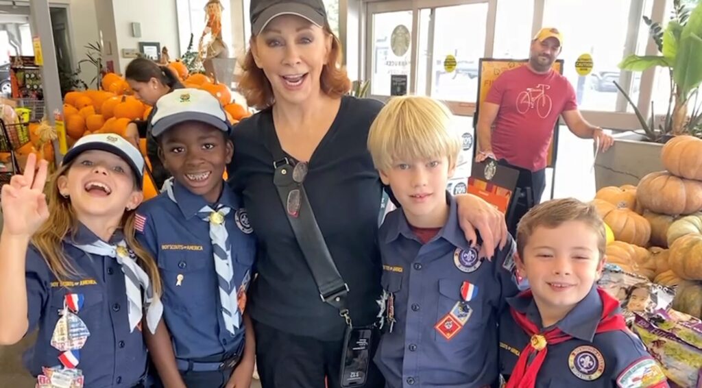 A photo of Reba McEntire and a group of Cub Scouts