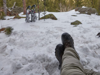 A photo showing the view from a tent of a wintry landscape during a winter campout.