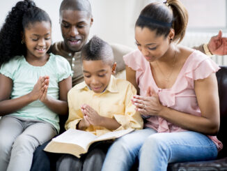 A photo of a family praying together
