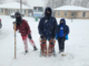 A photo of three Scouts bundled up during a snowstorm