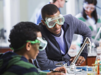 A photo of Scouts BSA-aged youth working on a chemistry experiment