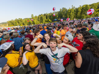 Scouts dancing and being excited and playing with beach balls at the Delta Base camp Bash during the 2023 National Scout Jamboree at The Summit Bechtel Reserve in Mount Hope, West Virginia