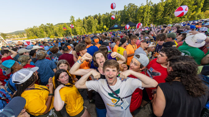 Scouts dancing and being excited and playing with beach balls at the Delta Base camp Bash during the 2023 National Scout Jamboree at The Summit Bechtel Reserve in Mount Hope, West Virginia