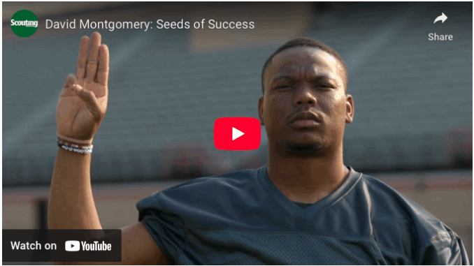 A screenshot of a Scouting America TV commercial featuring NFL running back David Montgomery
