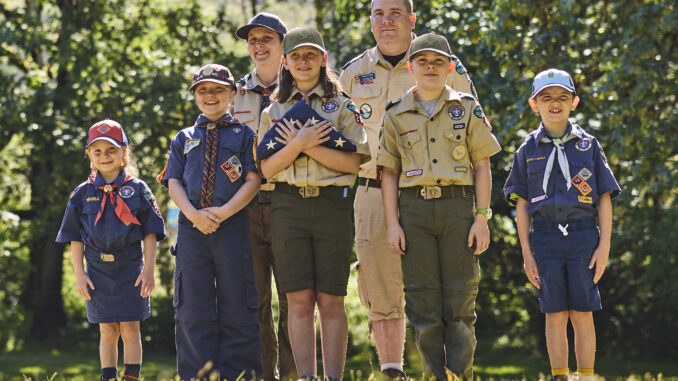 A photo of a group of Cub Scouts performing a flag ceremony while wearing their uniforms