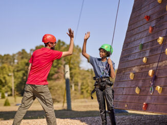high-five at the climbing wall - Scouts BSA photo 2024