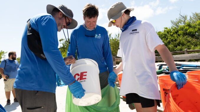 A photo of Scouts picking up trash near the ocean